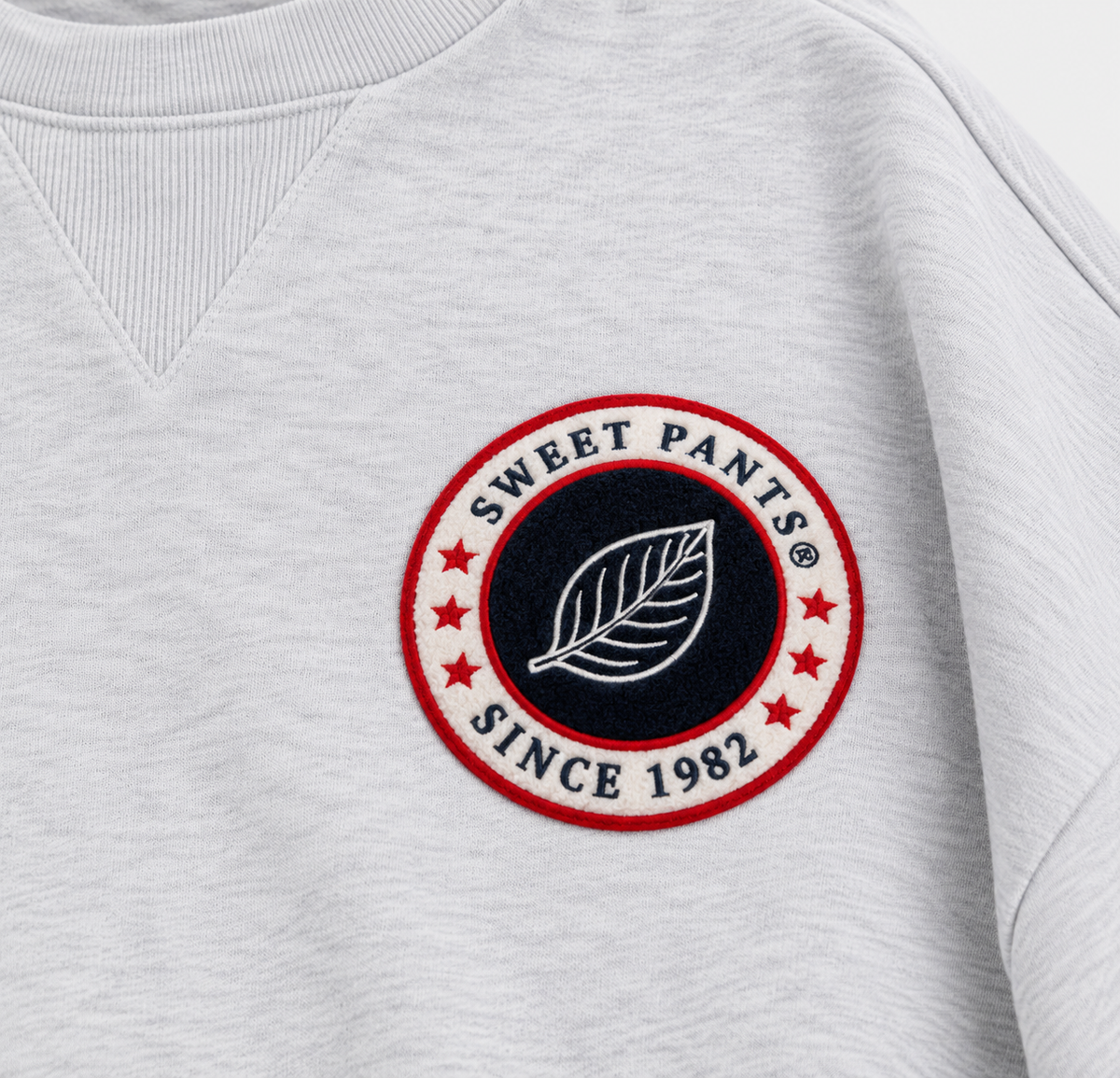 Gros plan sur le patch bouclette tricolore Sweet Pants du sweat Gym Crew Ice Marl