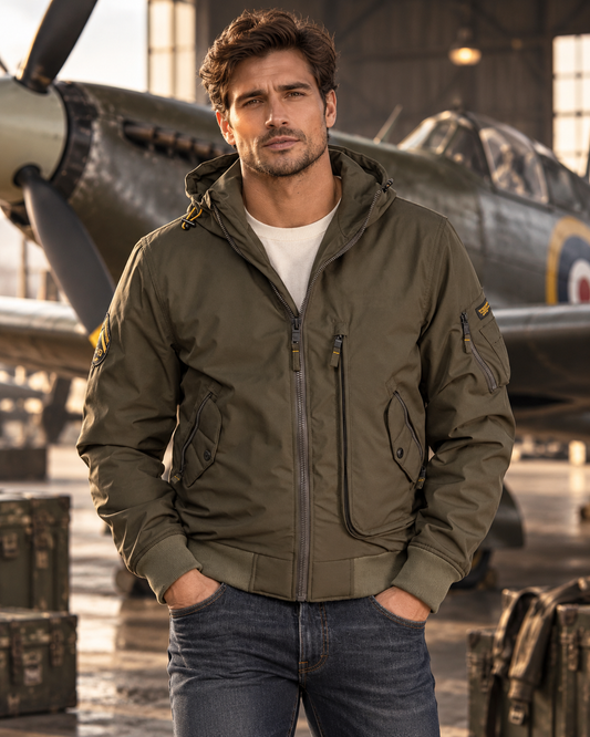 Blouson aviation kaki porté homme devant avion de chasse vintage